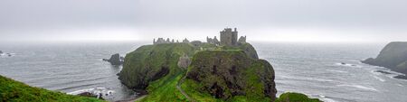 A panorama of scenic Dunnotar Castle and North Sea coastline in regular poor weather in Scotland during autumn season, Aberdeenshire, United Kingdomのeditorial素材