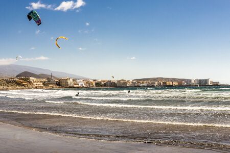 Tourists enjoy kite surfing at Playa Leocadio Machado beach at El Medano town, Tenerife, Spainのeditorial素材