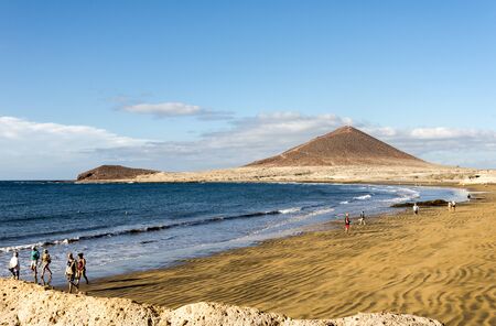 People walking on Playa de Leocadio Machado beach near El Medano town, Tenerife, Spainのeditorial素材