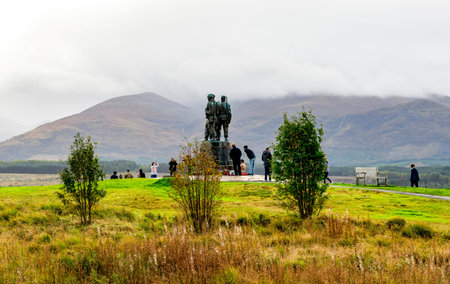 Tourists visiting the Commando Memorial monument in a cloudy weather near Spean Bridge village,...