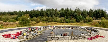 A circle shaped Garden of Remembrance with red wreathes and memorial plaques at the Commando Memorial, Lochaber, Scottish Highlandsのeditorial素材
