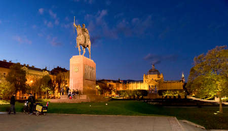 Tourists next to Old Zagreb Tour scenic old ride cars on St Catherine Square station, Zagreb, Croatiaのeditorial素材