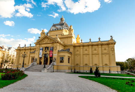 Tourists next to Old Zagreb Tour scenic old ride cars on St Catherine Square station, Zagreb, Croatiaのeditorial素材