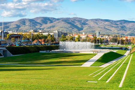 Tourists next to Old Zagreb Tour scenic old ride cars on St Catherine Square station, Zagreb, Croatiaのeditorial素材