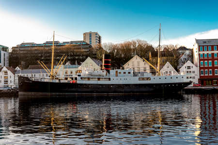 A view to Byparken city park and frozen lake with white swans and decorated trees in winter evening, Stavanger, Norway, December 2017のeditorial素材