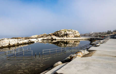 Walk path with a fence at scenic Sjobadet Myklebust public sea swimming pool in Tananger, Norway, May 2018の写真素材