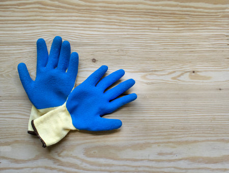 Blue protective rubber gloves for construction and operation with caustic substances on a bright...