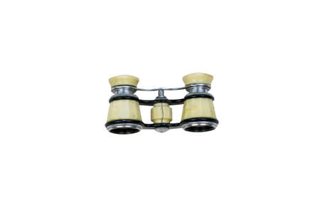Isolated opera glasses on a white background. Old vintage ivory pair of opera glasses. Elegant small theater binocular.の写真素材
