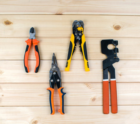Carpentry tooling on table. Set of tools for repair, scissors, flat-nose pliers. Top view of...