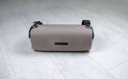 Portable grey speaker with the removable soft handle. Connect with smartphone or pc to play the music. Close up,の写真素材