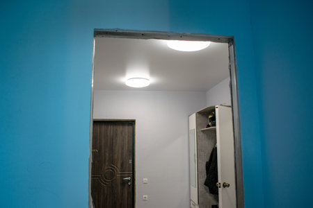 Doorway without door. Plastered blue, gray walls. The white closet in the hallway. Modern interior...