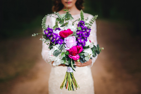 Beautiful wedding bouquet in hands of the brideの写真素材