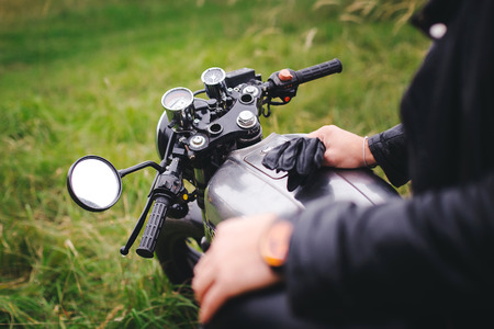 young man sitting on a motorcycleの写真素材
