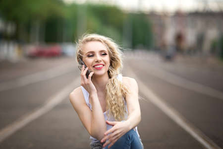 Beautiful girl talking on the phone. Lifestyle.の写真素材