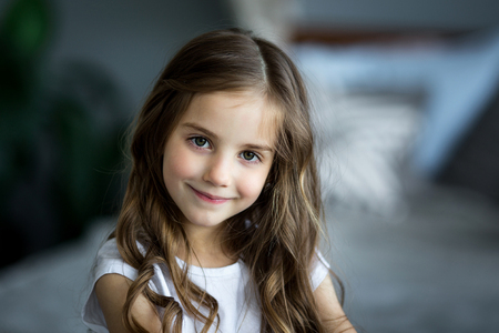 Portrait of a beautiful girl with a brown toy bearの写真素材