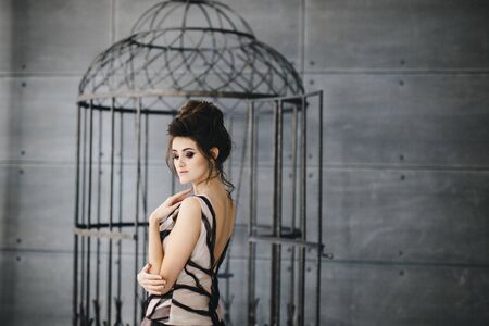 Portrait of a beautiful brunette with bright makeup on a dark background. fashion woman.の写真素材
