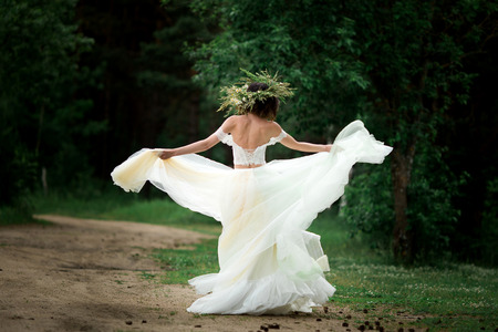 The bride is spinning in her wedding dressの写真素材