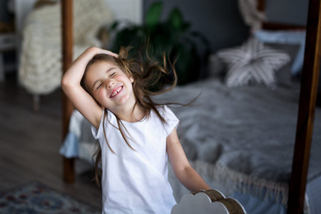 Cute little girl riding a toy horseの写真素材