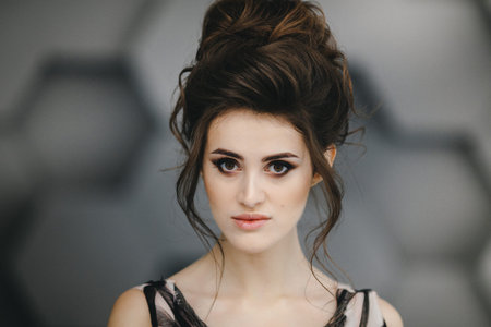 Portrait of a beautiful brunette with bright makeup on a dark background. fashion woman.