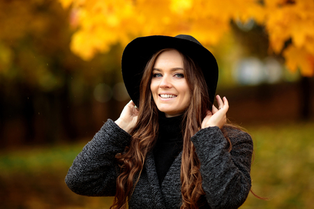 Portrait of very beautiful woman in autumn parkの写真素材