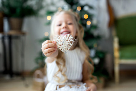 A little cute girl dreams of gifts. A cute girl making a wish. Merry Christmas and Happy Holidaysの写真素材