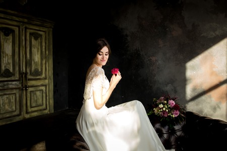 Wedding fashion bride with bouquet in hands. Portrait of beauty bride in white dress.の写真素材