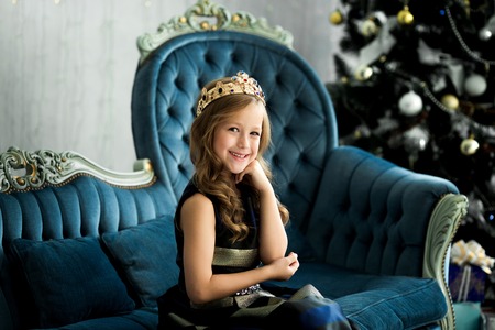 Portrait of a beautiful smiling little girl in the studio. Merry Christmas and Happy Holidays.の写真素材