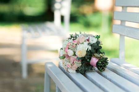 Colorful bridal bouquet lies on a bench. Wedding day.の写真素材