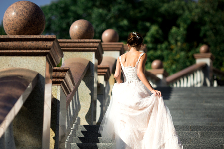 fashion photo of beautiful woman in wedding dress posing outdoor.の写真素材