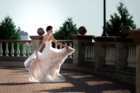 fashion photo of beautiful woman in wedding dress posing outdoor.の写真素材