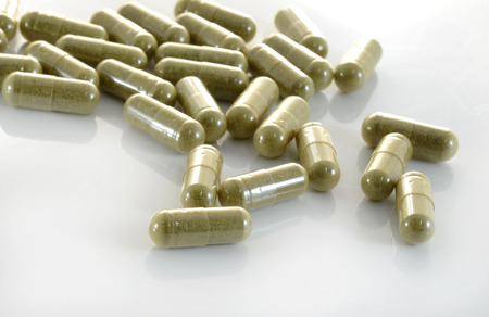 herb capsule with green herbal leafの写真素材