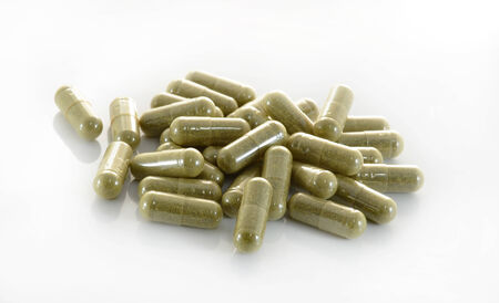 herb capsule with green herbal leafの写真素材