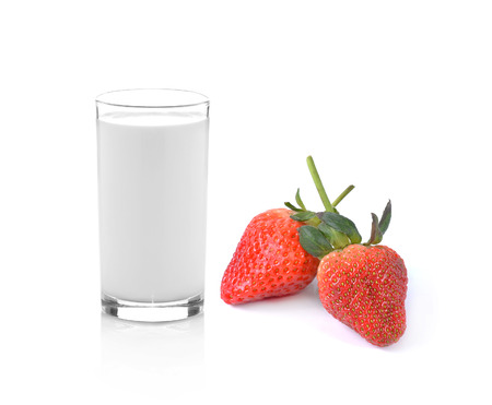 glass of milk and strawberry on white backgroundの写真素材