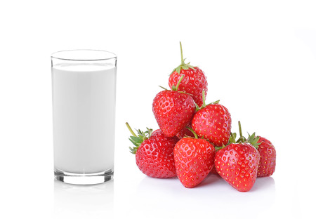 glass of milk and strawberry on white backgroundの写真素材