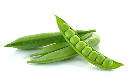 fresh green peas isolated on a white backgroundの写真素材
