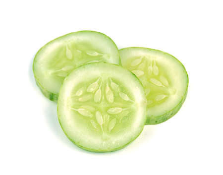 Cucumber and slices isolated white backgroundの写真素材