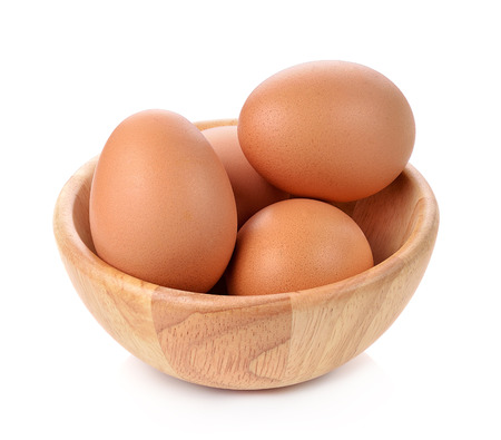 eggs in a wooden bowl isolated on white backgroundの写真素材
