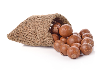 Macadamia nuts in the bag on white backgroundの写真素材