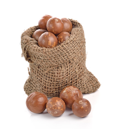 Macadamia nuts in the bag on white backgroundの写真素材