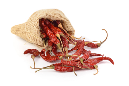 dried hot red chillies in a sack on white backgroudの写真素材