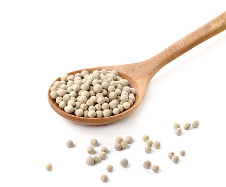 Wooden spoon and peppercorn on white backgroundの写真素材