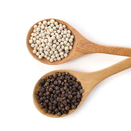 Wooden spoon and peppercorn on white backgroundの写真素材