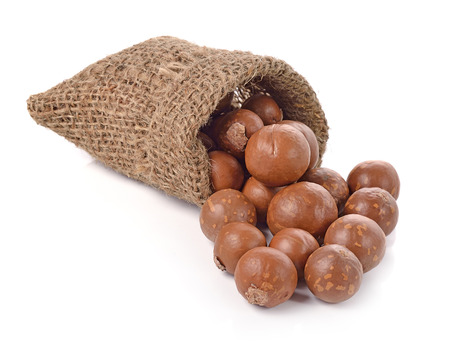 Macadamia nuts in the bag on white backgroundの写真素材