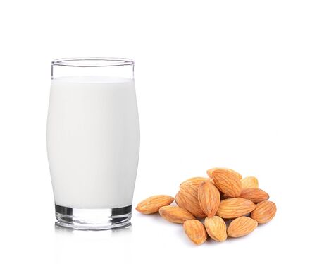 Glass of fresh milk and almonds isolated on white  background.の写真素材