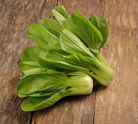 Overhead shot of Chinese cabbage, Bok Choy, on rustic woodの写真素材
