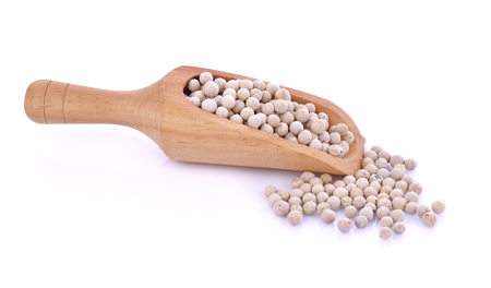 Wooden spoon and peppercorn on white backgroundの写真素材