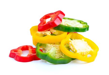 red, green and yellow sliced pepper isolated on white backgroundの写真素材