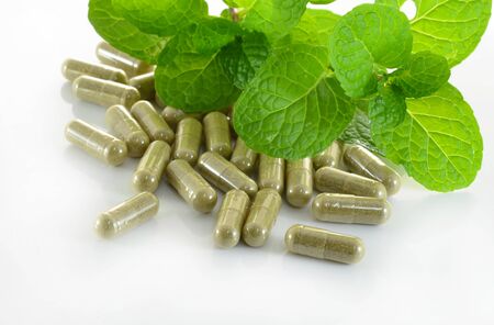 herb capsule with green herbal leafの写真素材