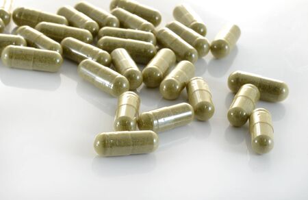 herb capsule with green herbal leafの写真素材
