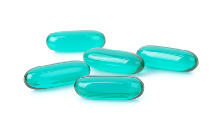Blue Transparent pills content medicine capsule on white background.の写真素材